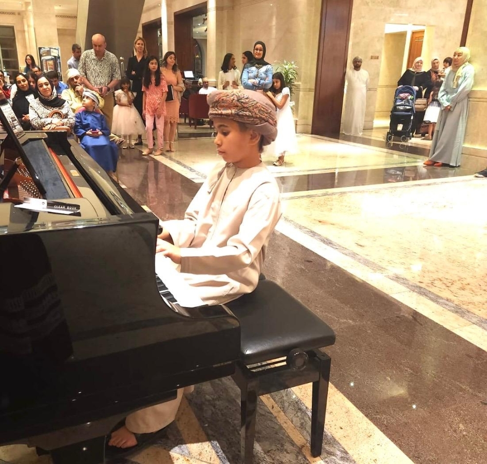 Sulaiman al Fahdi  playing a piano at a Muscat concert