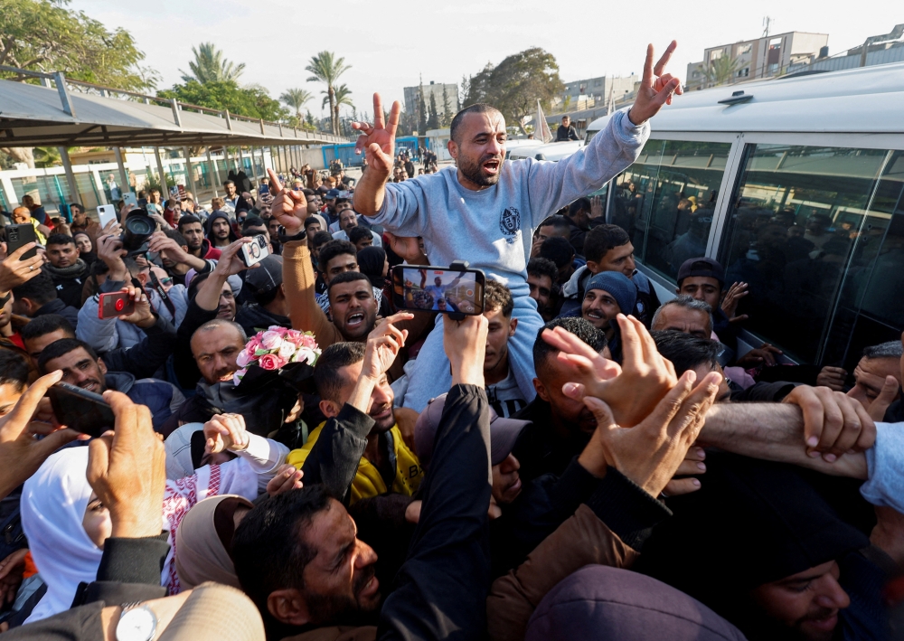 A freed Palestinian prisoner gestures as he is greeted by people after being released by Israel as part of a hostages-prisoners swap and a ceasefire deal in Gaza, in Khan Younis. — Reuters 
