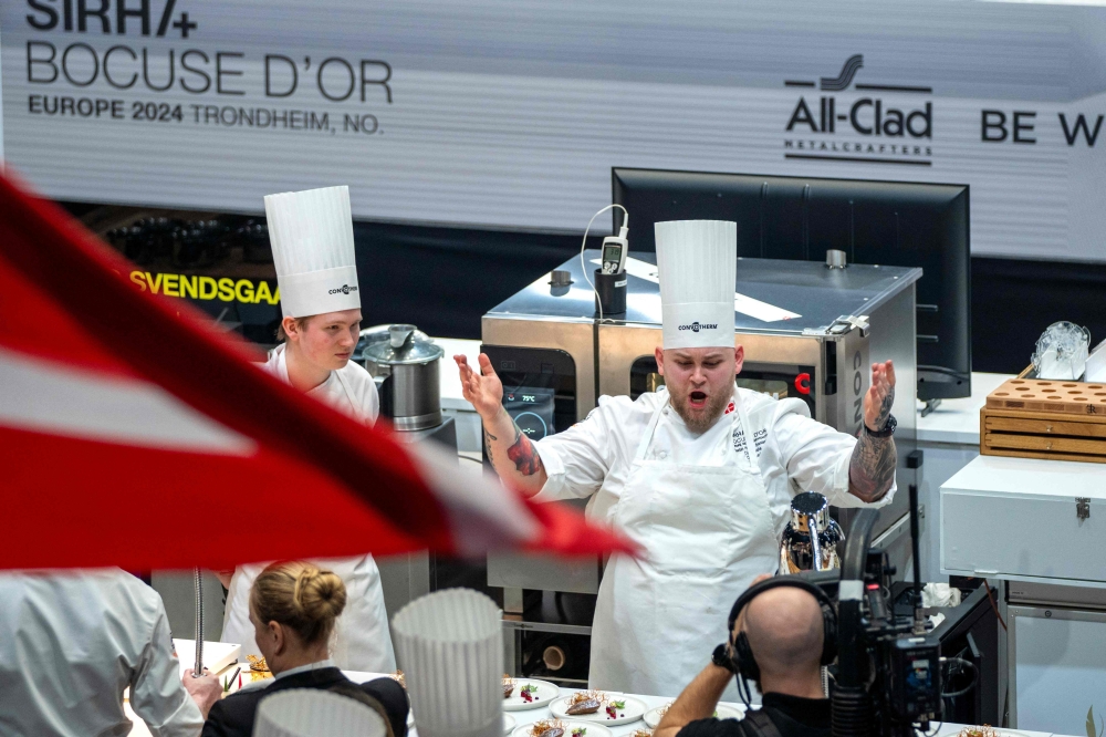 Picture taken on March 19, 2024 in Trondheim, Norway, shows Danish chef Sebastian Holberg Svendsgaard (C) during the European final in the Bocuse d'Or Europe competition in Trondheim Spektrum. Struggling at school but eager to compete, Danish chef Sebastian Holberg Svendsgaard is hoping to win the Bocuse d'Or in Lyon on Monday, January 27, 2025, the ultimate title in the culinary "Olympics". - Norway OUT
 (Photo by Gorm Kallestad / NTB / AFP)

