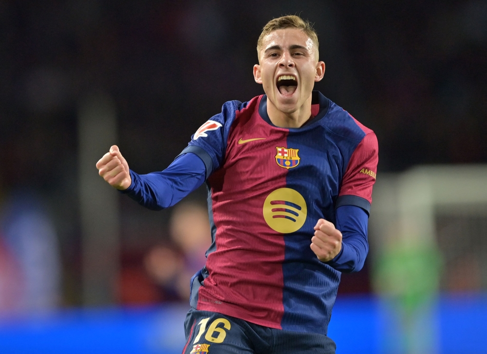 Barcelona's Spanish midfielder #16 Fermin Lopez celebrates scoring his team's fourth goal during the Spanish league football match between FC Barcelona and Valencia CF at the Estadi Olimpic Lluis Companys in Barcelona on January 26, 2025. (Photo by MANAURE QUINTERO / AFP)
