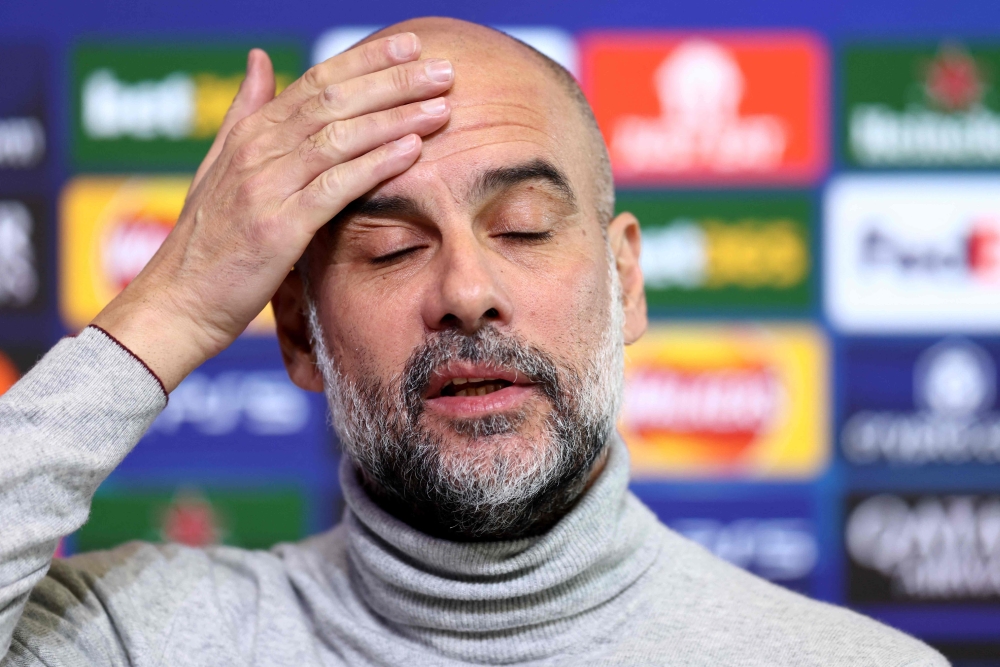 Manchester City's Spanish manager Pep Guardiola reacts during a press conference at Manchester City's training ground in Manchester, north-west England, on January 28, 2025, on the eve of their UEFA Champions League football match against Club Brugge. (Photo by Darren Staples / AFP)

