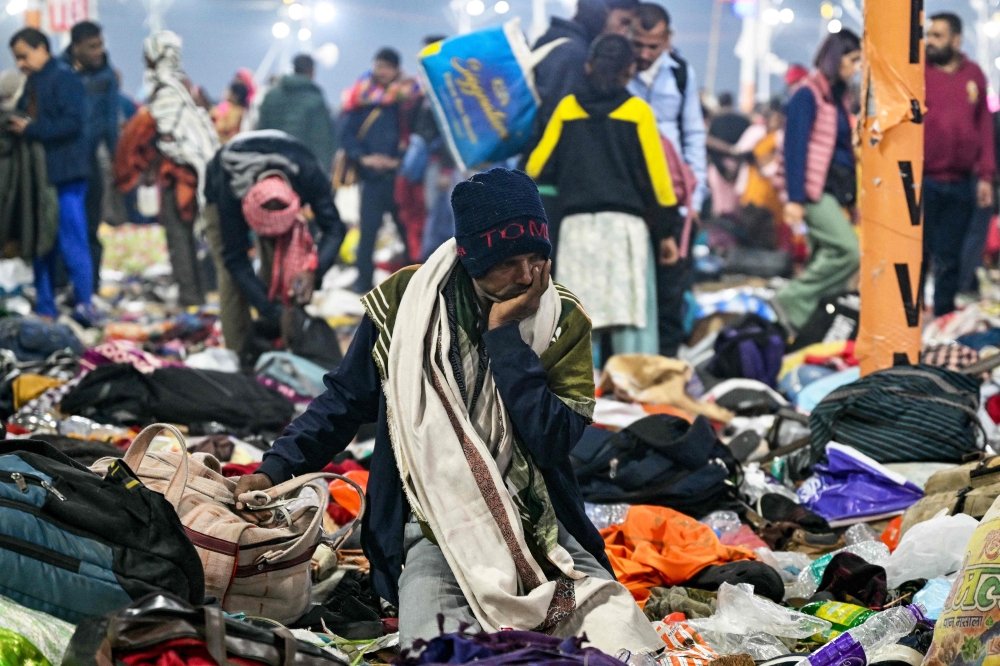 A family member of a victim looks on as he sits at the site of a stampede, during the Maha Kumbh Mela festival in Prayagraj 