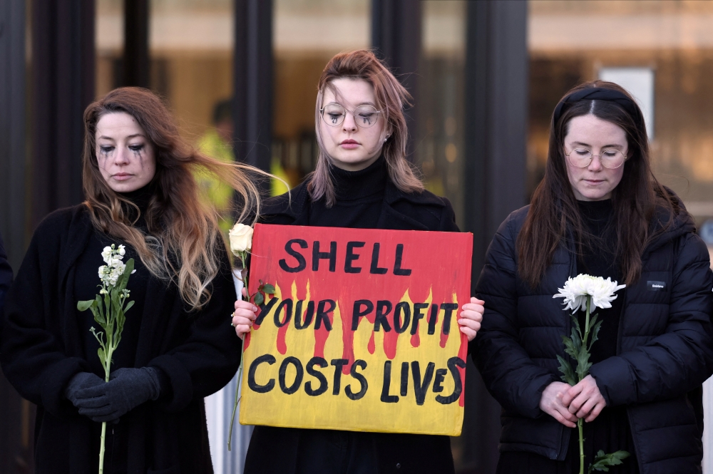 Climate activists protest outside Shell's global headquarters in London. - Reuters