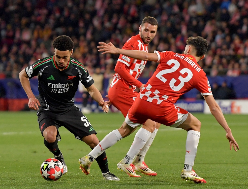 Arsenal's English midfielder #53 Ethan Nwaneri fights for the ball with Girona's Spanish midfielder #23 Ivan Martin (R) during the UEFA Champions League, league phase football match between Girona FC and Arsenal FC at the Montilivi stadium in Girona on January 29, 2025. (Photo by MANAURE QUINTERO / AFP)

