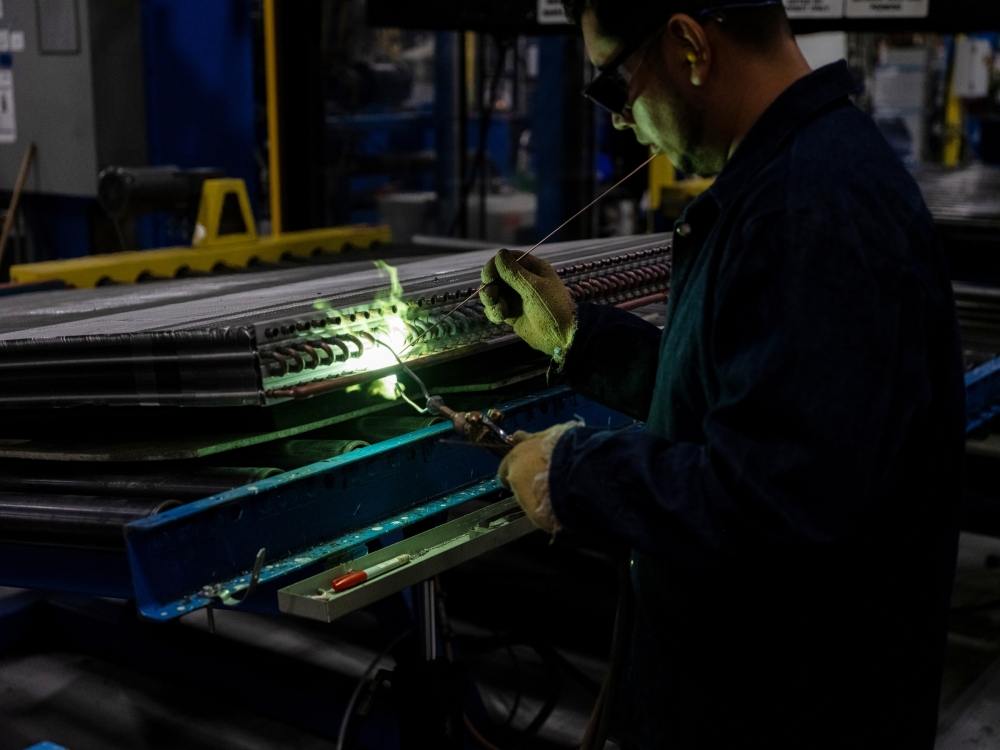 Soldering work at a factory that makes air-conditioning units for the American company Trane, outside Monterrey, Mexico 