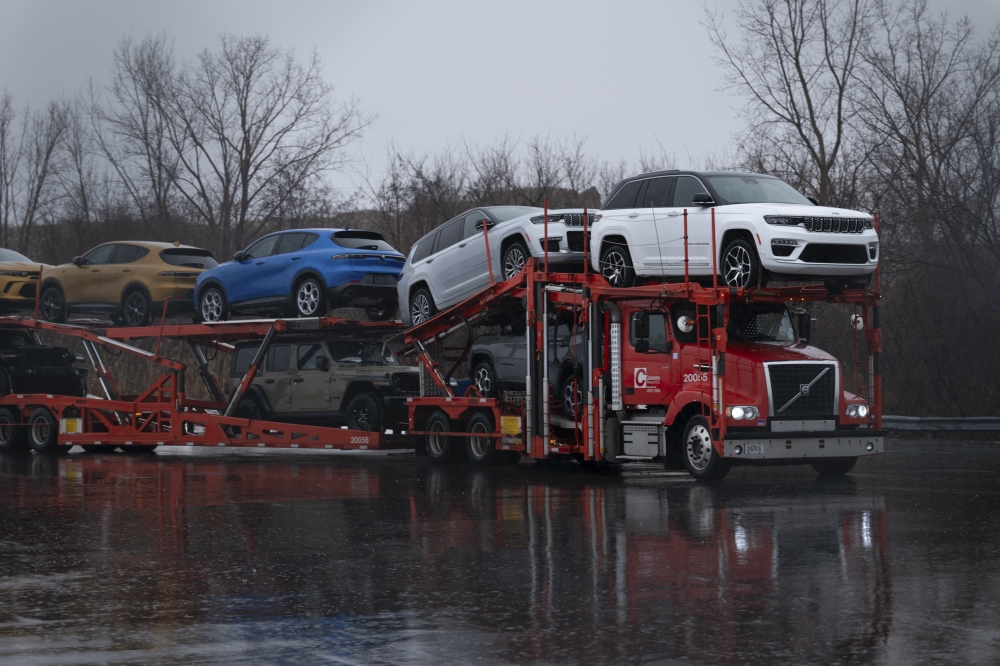 A car hauler truck transports vehicles in Windsor, Ontario, Canada, on Friday, Jan. 31, 2025. (Ian Willms/The New York Times)