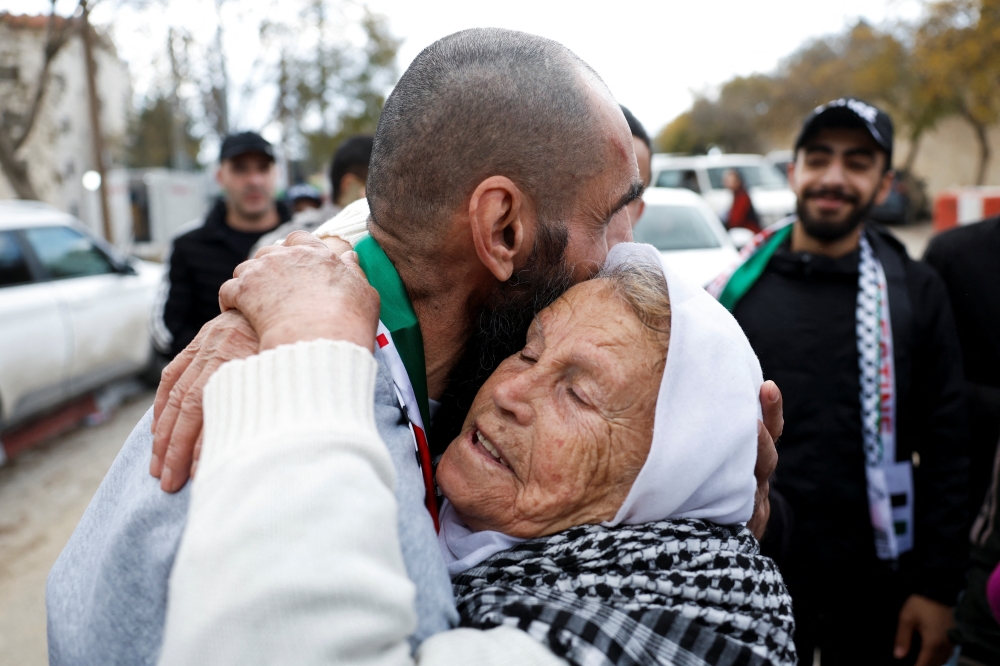 A freed Palestinian prisoner is greeted after being released from an Israeli jail in Ramallah on Saturday. — Reuters