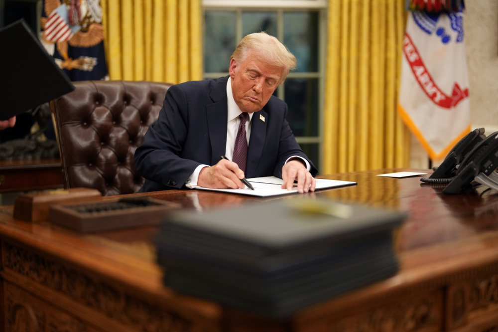 President Donald Trump signs executive orders in the Oval Office of the White House in Washington on Monday, Jan. 20, 2025. 