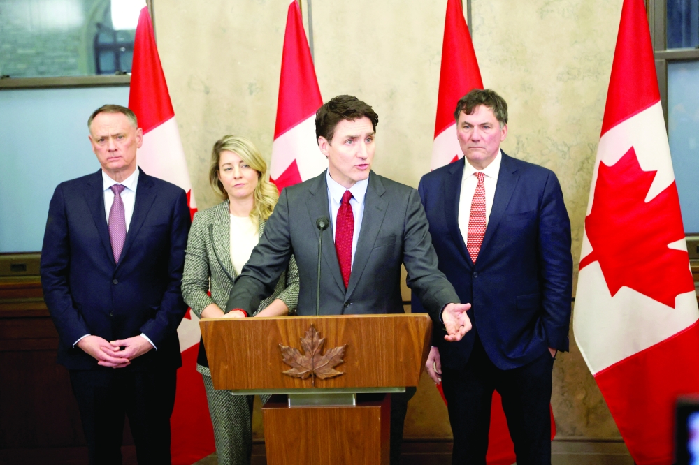Canada's PM Justin Trudeau is joined by Finance Minister Dominic LeBlanc, Minister of Foreign Affairs Melanie Joly, and Minister of Public Safety David McGuinty, as he speaks during a press conference in Ottawa, Canada. — AFP