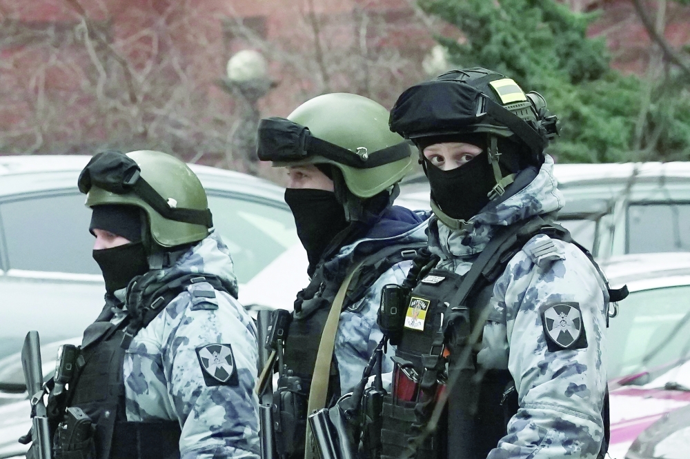 Russian law enforcement officers patrol an area next to a residential building following a blast in Moscow. — AFP 