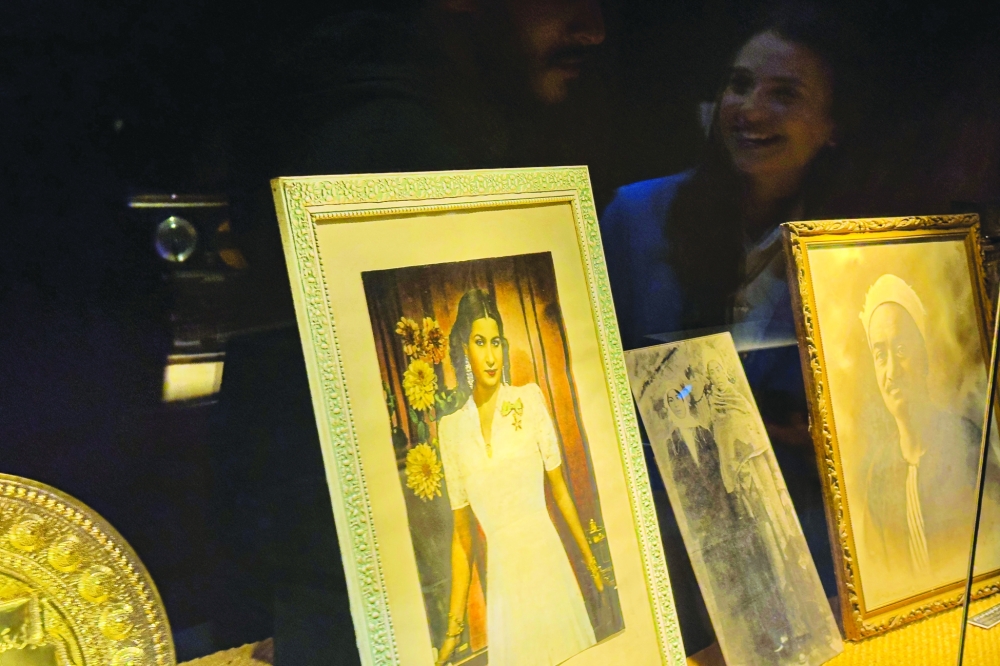 A picture of the late Egyptian singer Umm Kulthum (L) is displayed next to other photographs, at the biographical museum dedicated to her in Cairo on January 29, 2025. Umm Kulthum passed away in February 1975 but remains one of the most revered legends of music in the Arab world 50 years after her death, in Kuwait City. (Photo by Khaled DESOUKI / AFP)