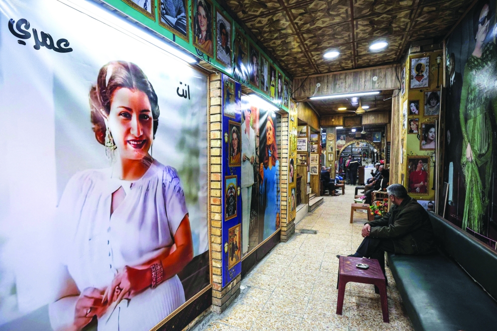 A man sits at the Umm Kulthum cafe, which opened in 1970 and is named after the late Egyptian Arabic music icon Umm Kulthum, along al-Rashid Street in the old city of Baghdad on January 27, 2025.  (Photo by AHMAD AL-RUBAYE / AFP)