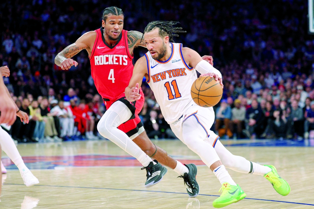 New York Knicks' Jalen Brunson (11) goes to the basket as Houston Rockets' Jalen Green (4) defends at Madison Square Garden. -- Imagn Images