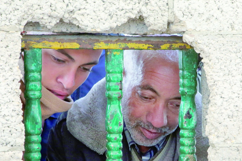 Palestinians wait to receive aid at a distribution point in Khan Yunis in the southern Gaza Strip on Tuesday. — Reuters