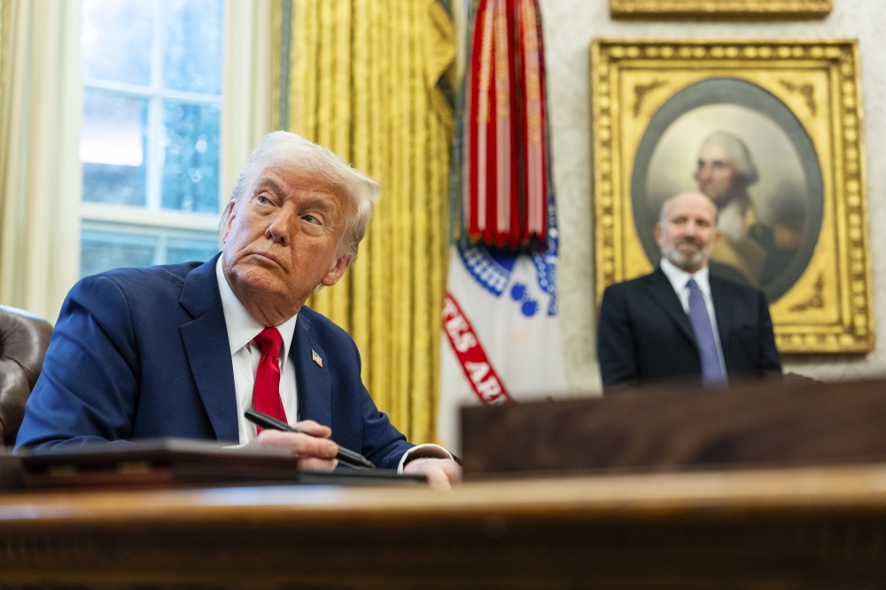 President Donald Trump speaks to reporters as he signs initiatives and executive orders in the Oval Office of the White House in Washington, on Monday, Feb 3, 2025. — The New York Times