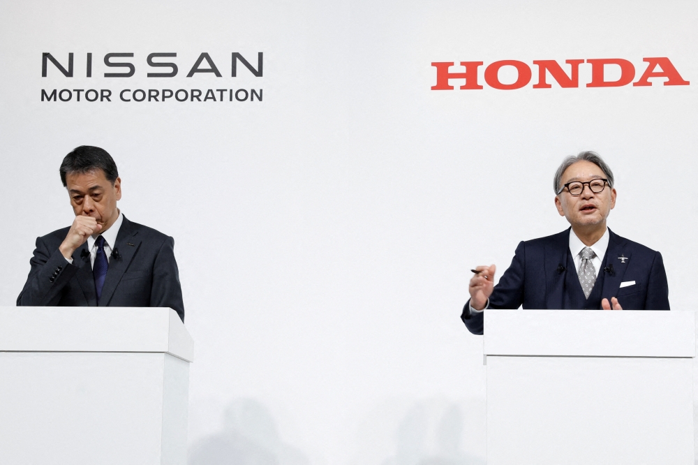 Makoto Uchida, President and CEO of Nissan Motor Corporation, and Toshihiro Mibe, Director, President, and Representative Executive Officer of Honda, attend a joint press conference on their merger talks on December 23, 2024. 