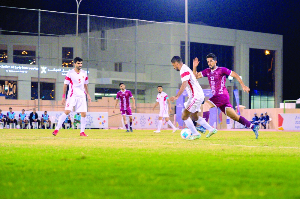 The Royal Court Affairs and State Audit Institution players fight for the ball.