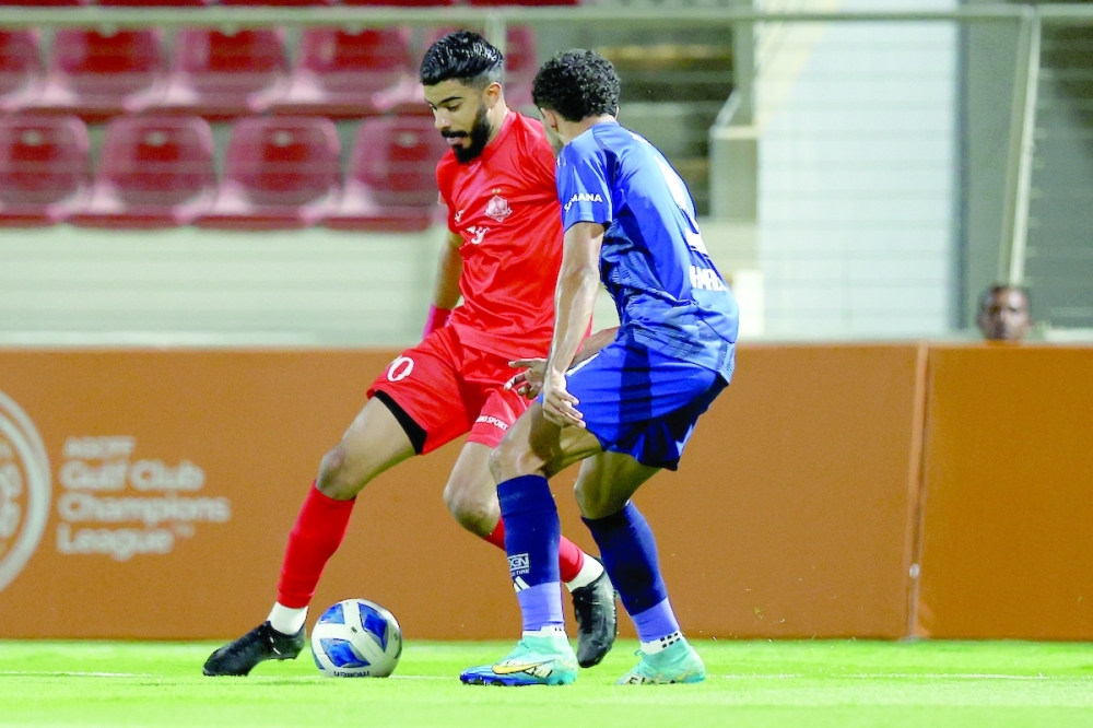Oman's Dhofar Club and UAE's Al Nasr Club players in action.