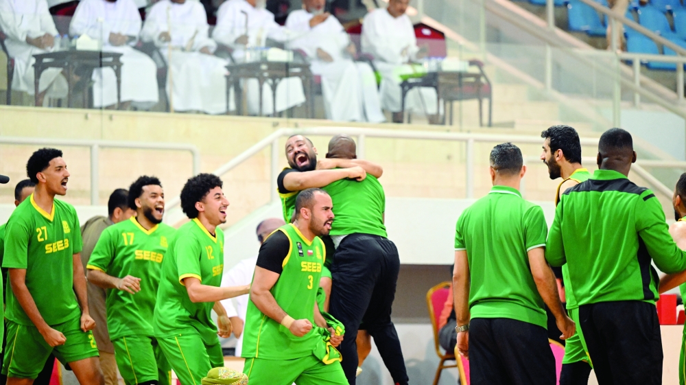Seeb players and support staff celebrate after the win.