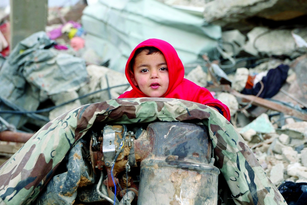 A Palestinian child is pictured amid the rubble of destroyed buildings at Saftawi street in Jabalia, in the northern Gaza Strip, on Wednesday. - AFP
