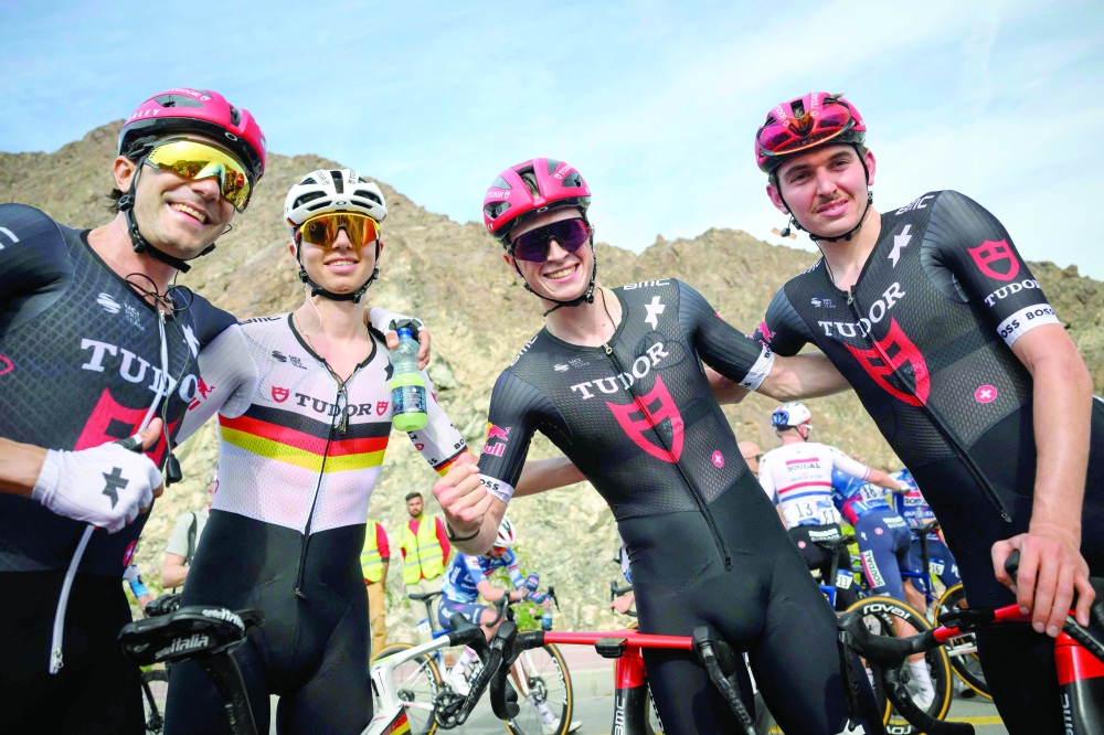 Tudor Pro Cycling Team's netherland rider Rick Pluimers (3rd L) celebrates with teammates after winning the Muscat Classic cycling race, in Muscat on February 7, 2025. (Photo by Loic VENANCE / AFP)

