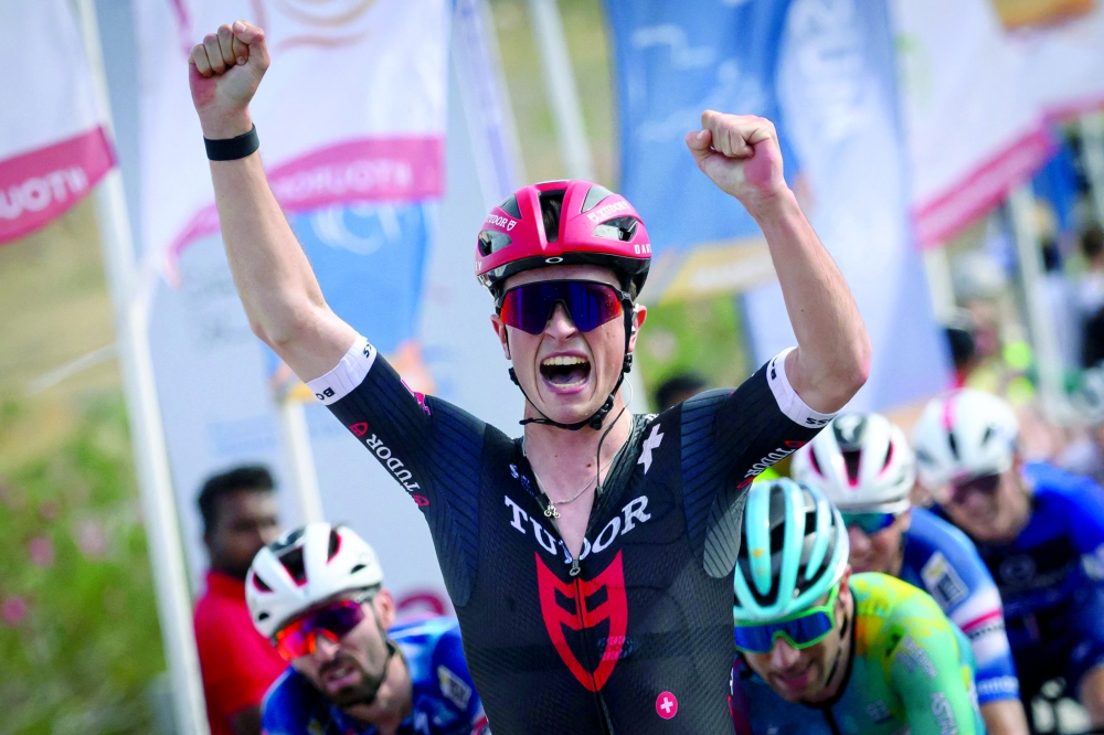 Tudor Pro Cycling Team's Netherland rider Rick Pluimers celebrates as he crosses the finish line to win the one day Muscat Classic cycling race. in Muscat on February 7, 2025. (Photo by Loic VENANCE / AFP)

