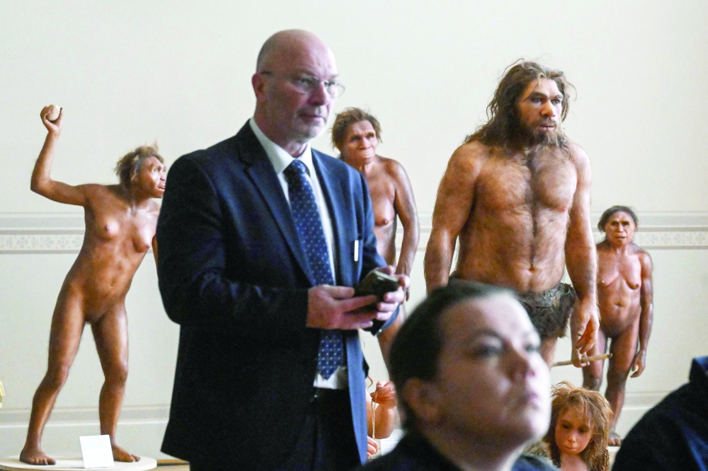 Visitors listen next to the hyperrealistic artistic reconstruction of the human ancestors in the National Museum of Prague on February 4, 2025 in Prague, to a press conference held by the Czech Prime Minister and Ethiopia's Tourism Minister (both unseen) about bone fragments of Lucy, a 3.18 million year-old human ancester which rarely leave Ethiopia, will go on display from August 25 in Prague, for the first time ever in Europe.  The ancient remains of the Australopithecus afarensis were discovered in Ethiopia in 1974. The find was, at the time, the most complete ever found, and revolutionised the understanding of humanity's ancestors. "Lucy's skeletal remains will be displayed in Europe for the first time ever," Prime Minister Petr Fiala told reporters as he announced the rare loan by Ethiopia's National Museum. The fragments will be shown at Prague's National Museum as part of a "Human Origins and Fossils" exhibition for two months from August 25.
