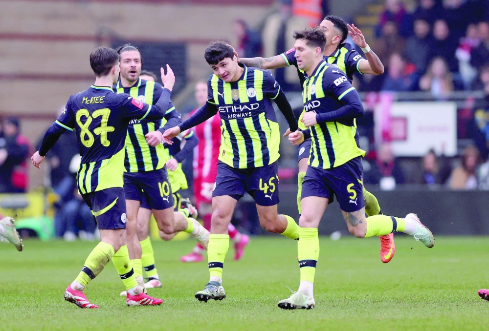 Manchester City's Khusanov celebrates with John, Jack and James. — Reuters