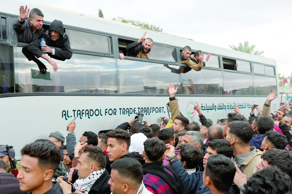Freed Palestinian prisoners are greeted after being released from an Israeli jail, in Khan Younis. — Reuters