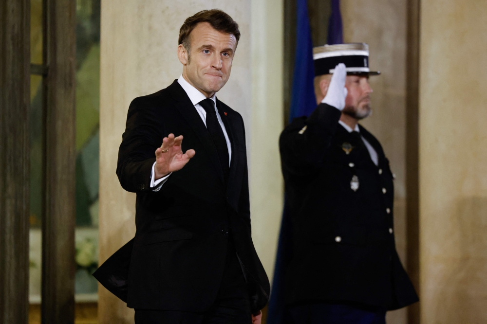 France's President Emmanuel Macron waves at the Elysee Palace in Paris. — AFP 