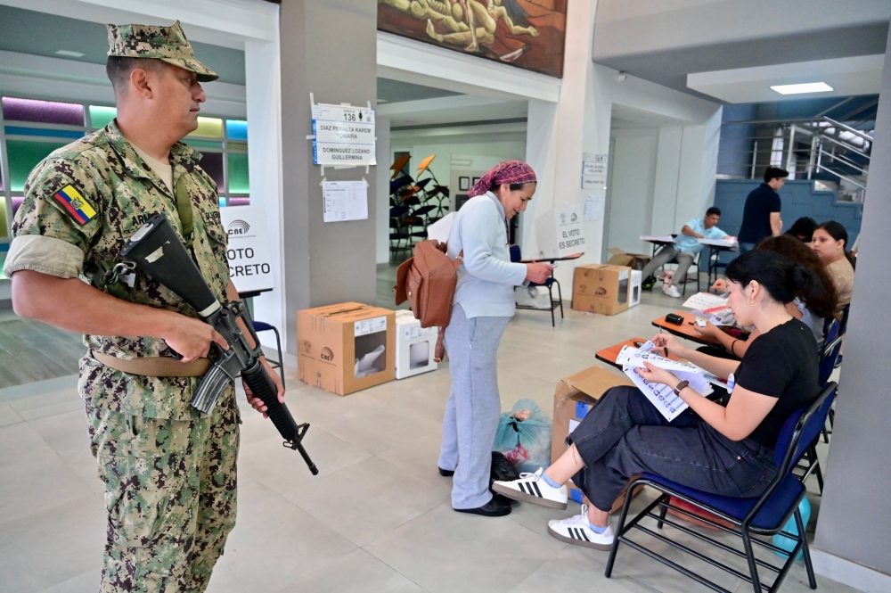 A military officer stands guard at a polling station during the presidential election in Guayaquil, Ecuador. — AFP