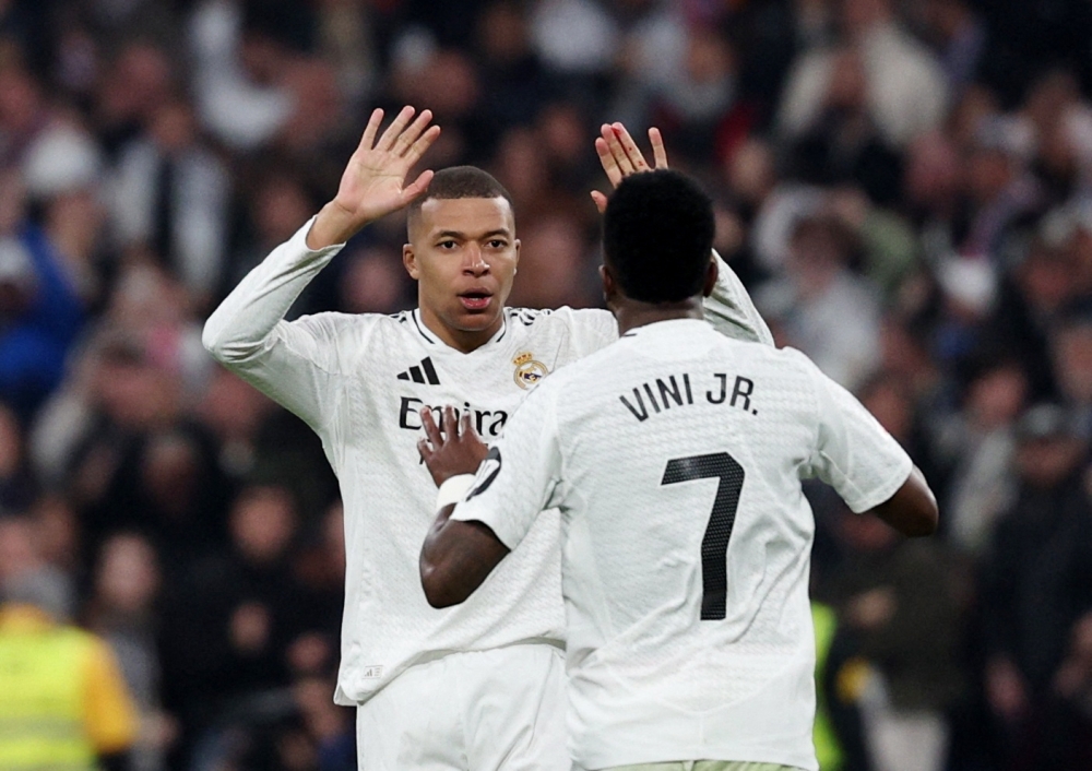 Real Madrid's Kylian Mbappe celebrates with Vinicius Junior after scoring their first goal.— Reuters