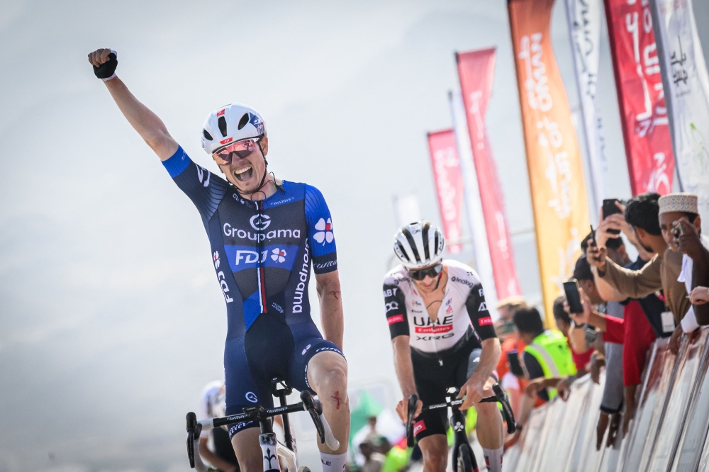 Groupama-FDJ team's French rider David Gaudu celebrates while crossing the finish line to win the third stage of the Tour of Oman cycling race from Fanja to Eastern Mountain, on February 10, 2025. (Photo by Loic VENANCE / AFP)

