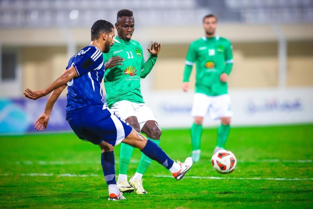 Al Nahda and Al Shabab players fight for the ball.