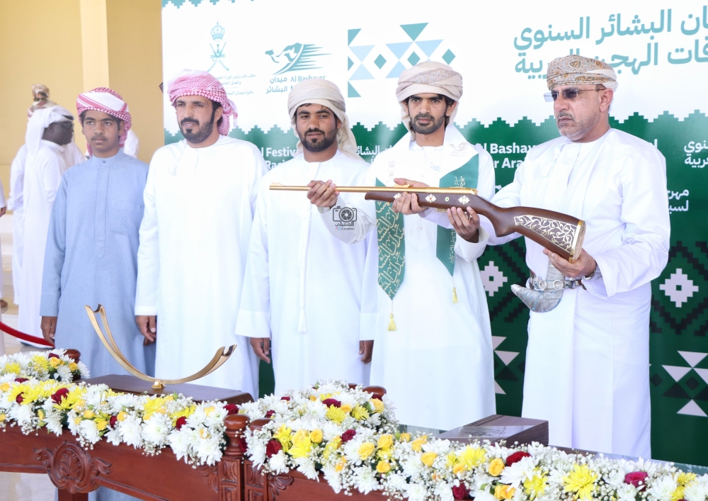 A winner being presented a gun.