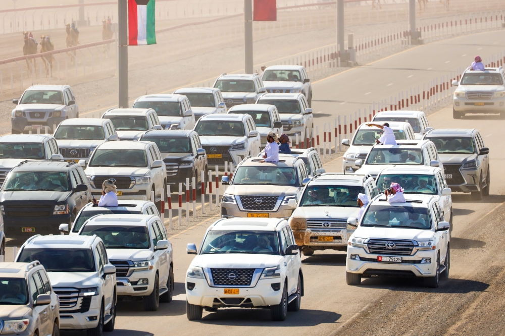 Camel owners follow up the races at Al Bashayer Festival.