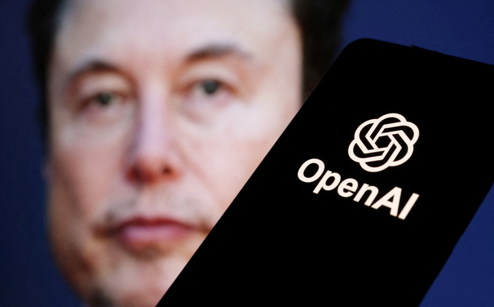 OpenAI logo is seen in front of Elon Musk photo