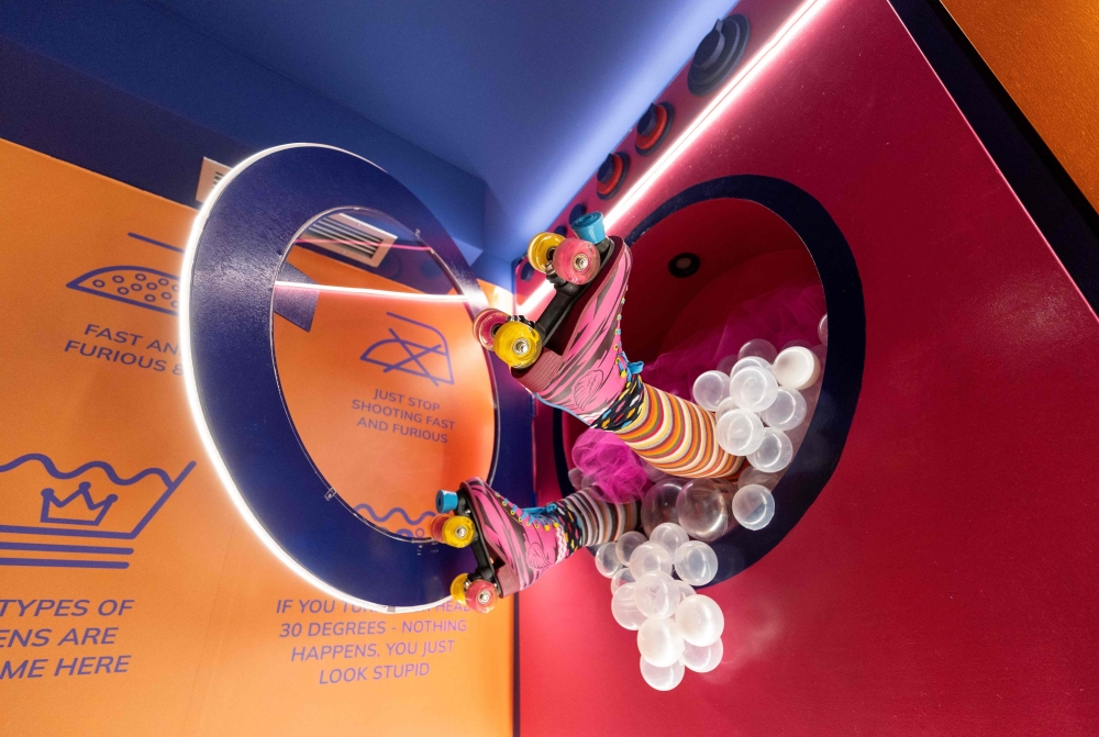 This photograph shows an installation depecting feet coming out a washing machine at the HaHaHouse museum of laughter in central Zagreb, on January 21, 2025.   The 450-square-metre (4,844-square-feet) museum, which opened in January, offers eight interactive zones and has also an educational part featuring the history of humour from ancient to modern times and via different formats -- theatre, film or Internet.  (Photo by Damir SENCAR / AFP)

