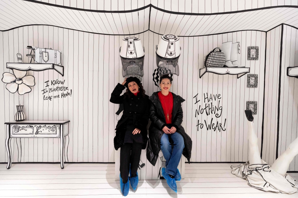 Visitors pose for pictures in a room at the HaHaHouse museum of laughter in central Zagreb, on January 21, 2025.   The 450-square-metre (4,844-square-feet) museum, which opened in January, offers eight interactive zones and has also an educational part featuring the history of humour from ancient to modern times and via different formats -- theatre, film or Internet.  (Photo by Damir SENCAR / AFP)

