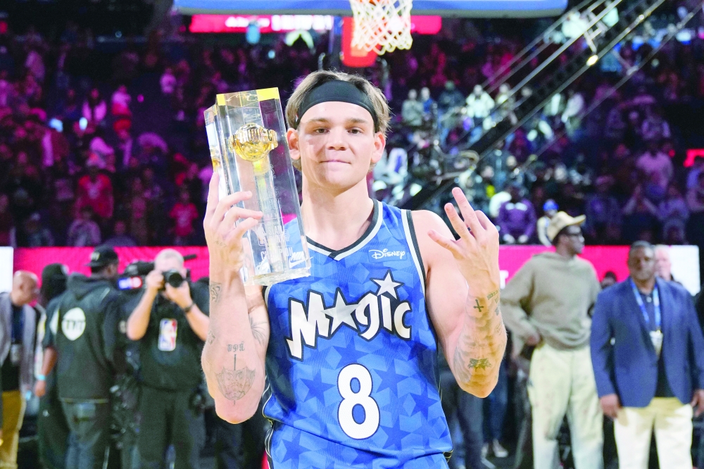 Mac McClung celebrates with the trophy. — Reuters
