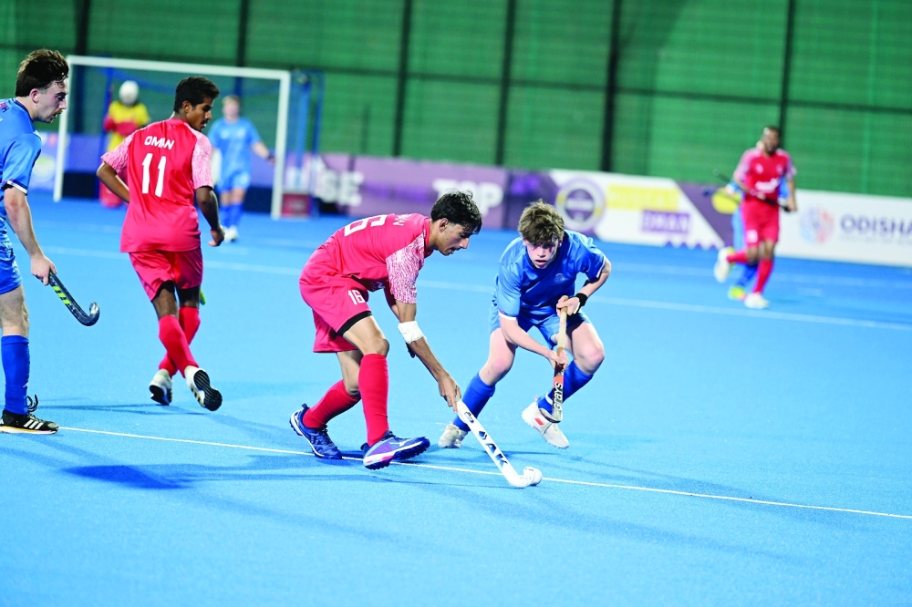 Oman and Scotland players fight for the ball.