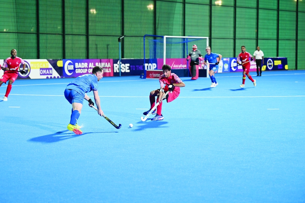 Oman and Scotland players fight for the ball.