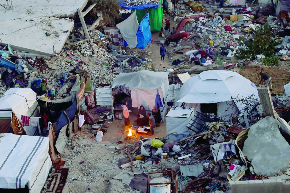 Palestinians camp amid the ruins of their houses in Jabalia in the northern Gaza Strip. — AFP