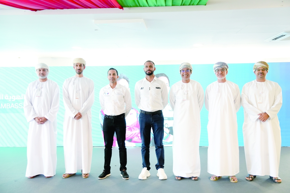 Ahmad al Harthy and Abdullah al Rawahi with the dignitaries during the singing ceremony.