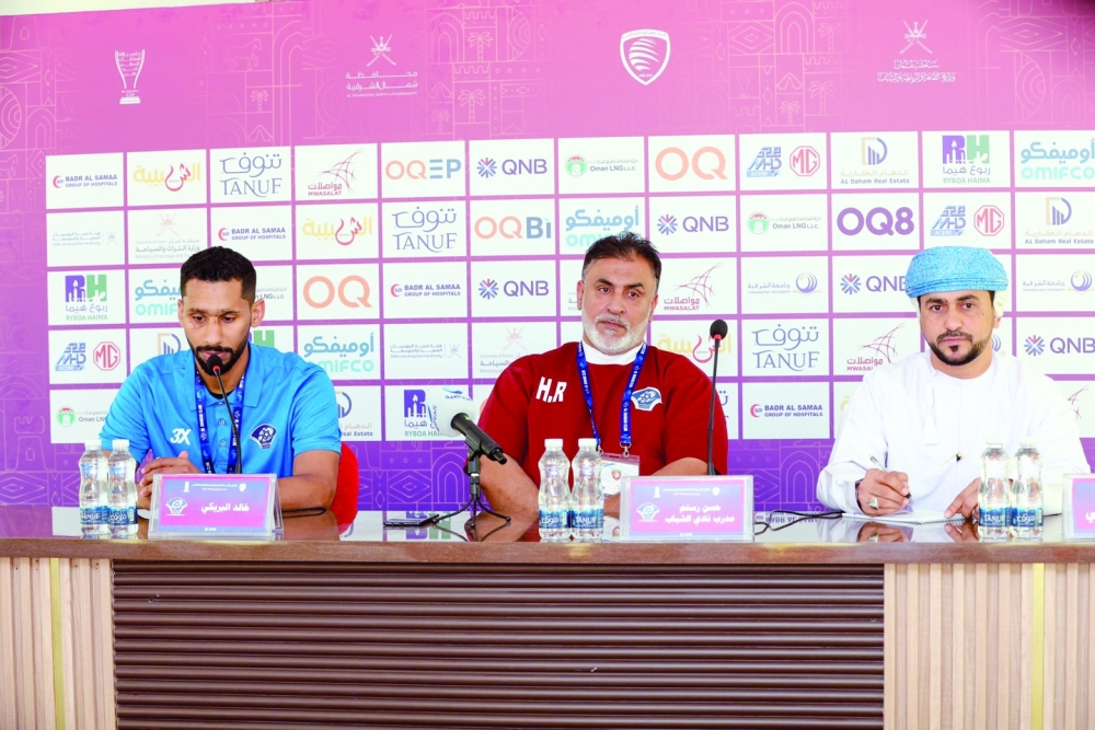 Al Shabab head coach Hassan Rustam (c) and Khalid al Braiki attend the press conference.