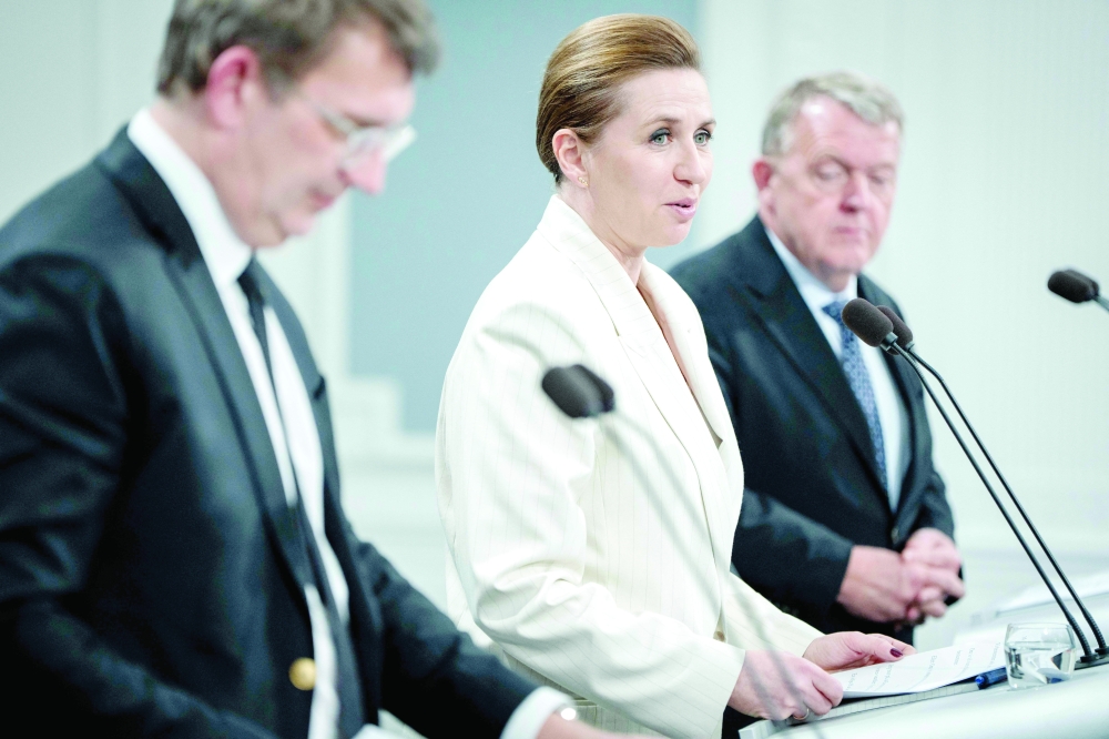 Denmark's Prime Minister Mette Frederiksen (C), Minister of Defence Troels Lund Poulsen (L) and Minister of Foreign Affairs Lars Lokke Rasmussen hold a press conference on strengthening the military's combat capability, at the Mirror Hall of the Prime Minister's Office in Copenhagen. - AFP