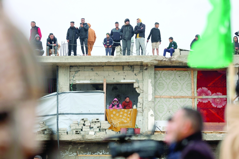 Palestinians gather at the site of the handing over of the bodies of four Israeli hostages in Khan Yunis in the southern Gaza. Hamas handed over the bodies of four hostages on Thursday. The transfer of the bodies is the first such handover of remains by Hamas. - AFP
