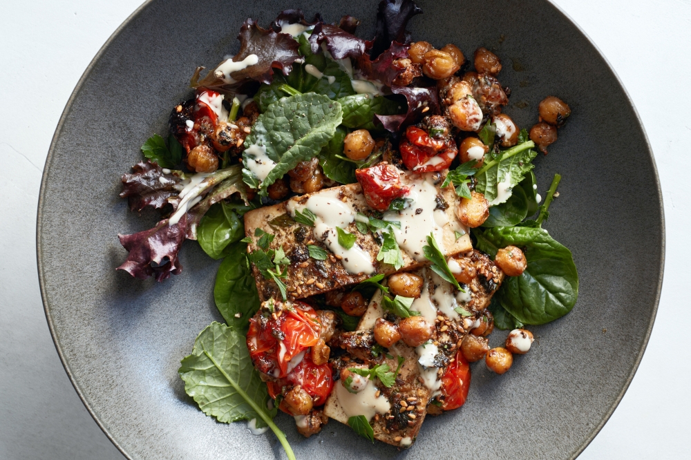 Zaatar roasted tofu with chickpeas, tomatoes and lemony tahini. Food stylist: Cybelle Tondu (Johnny Miller/The New York Times)