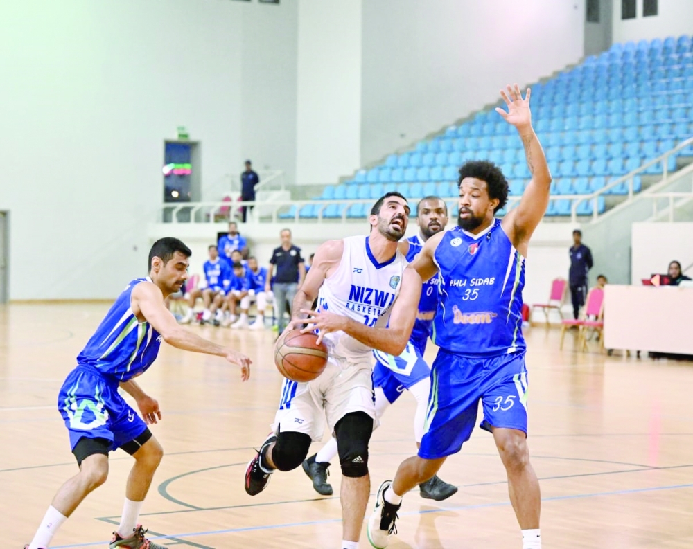 Ahli Sidab players defend a Nizwa attack. — Hussein Al Muqbali