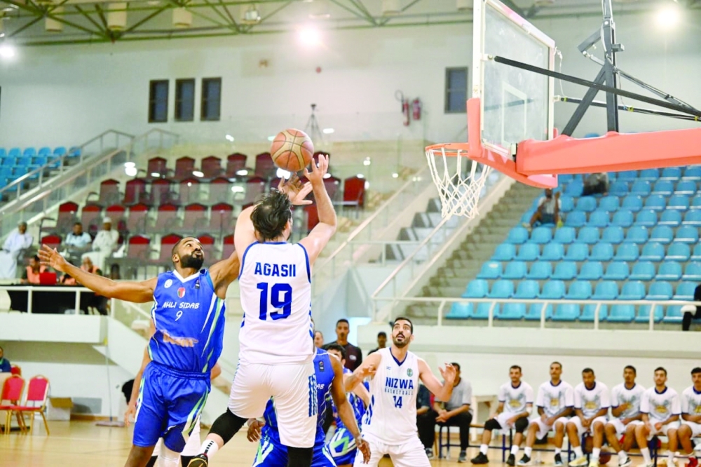 Nizwa's Agassi Tonion attempts a basket. — Hussein Al Muqbali